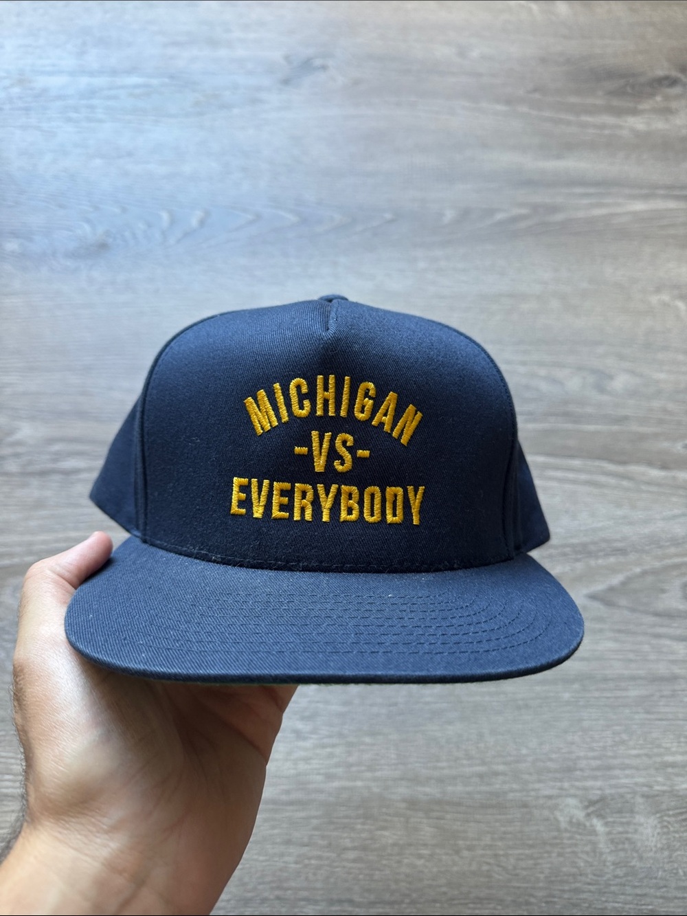 The Classic Navy Cap with Gold "Michigan -VS- Everybody" Embroidery